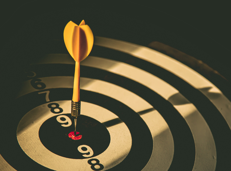 yellow dart placed in center of bullseye